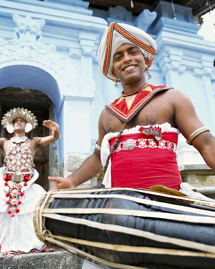 Kandyan drummer and traditional dancer performing cultural dance in Kandy