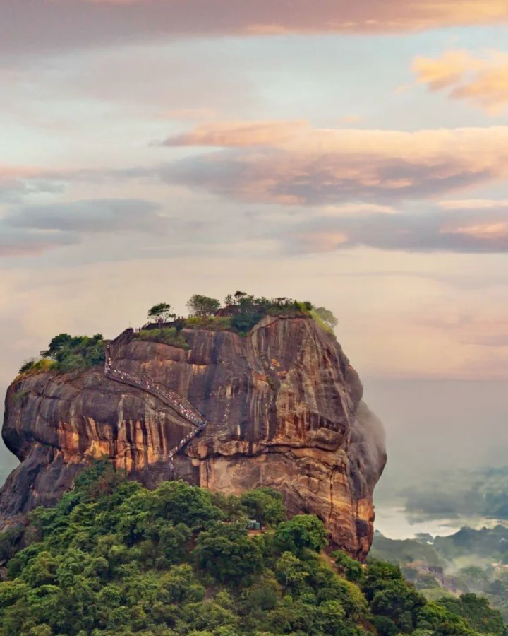 Sunset view of Sigiriya Rock rising above the jungle from Pidurangala near Dambulla
