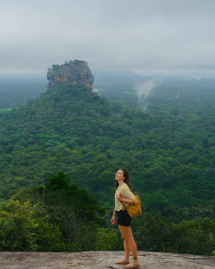 Traveler enjoying a scenic viewpoint overlooking forested landscapes near Dambulla
