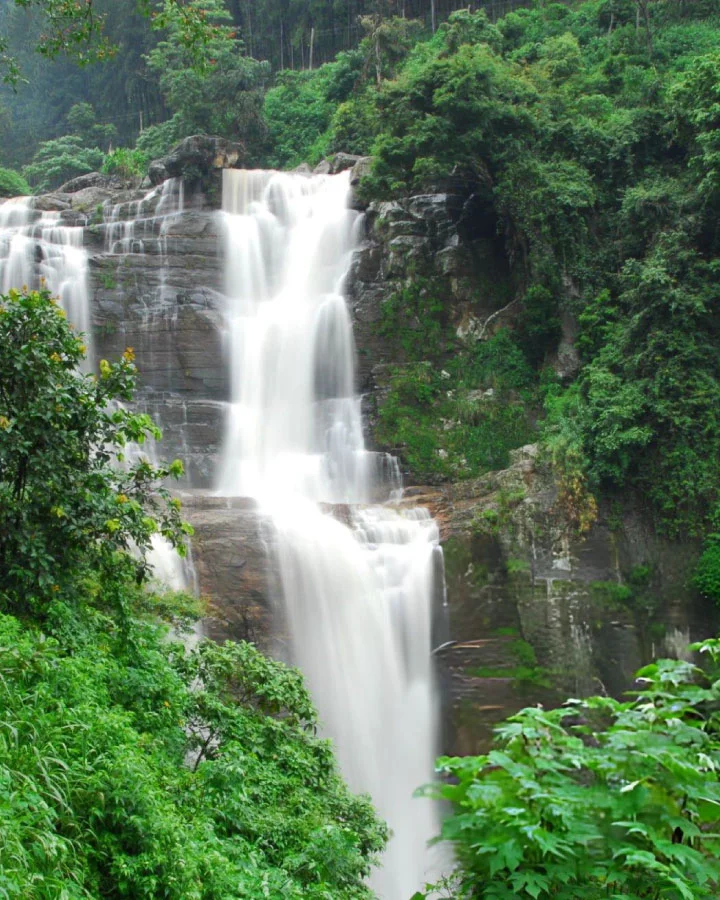 Waterfall flowing through dense greenery in the hill country near Nuwara Eliya